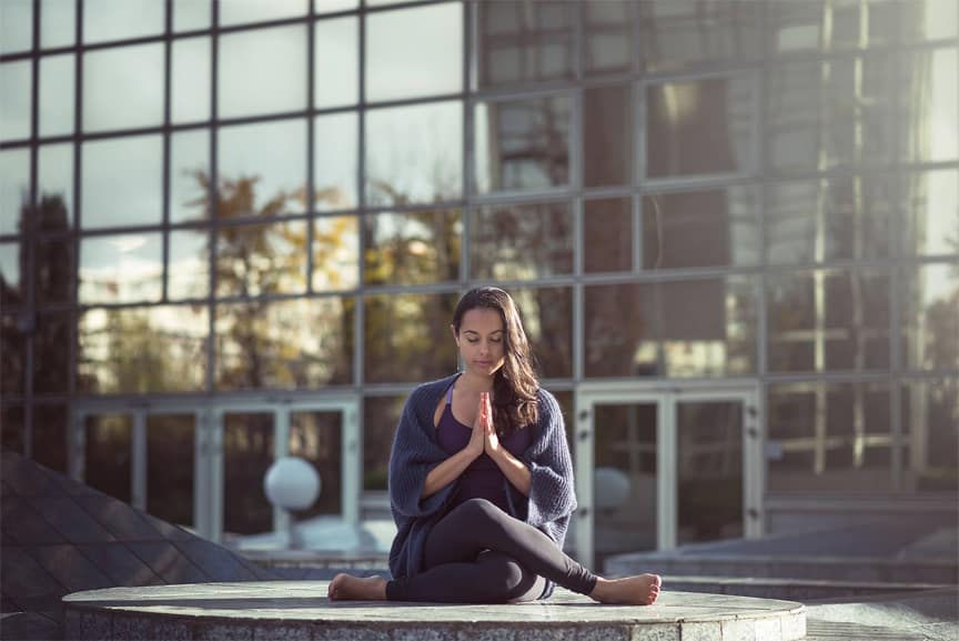 woman praying outside sitting yin yoga styles introduction basics what is benefits of yin yoga