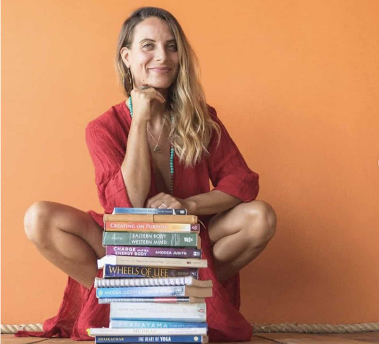 blonde woman with books how to start yoga at home