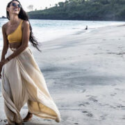 woman walking on beach with one piece outfit loft yoga jumpsuit wide leg casual